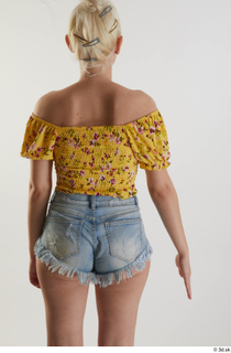 Lilly Bella 1 arm back view casual dressed flexing yellow…